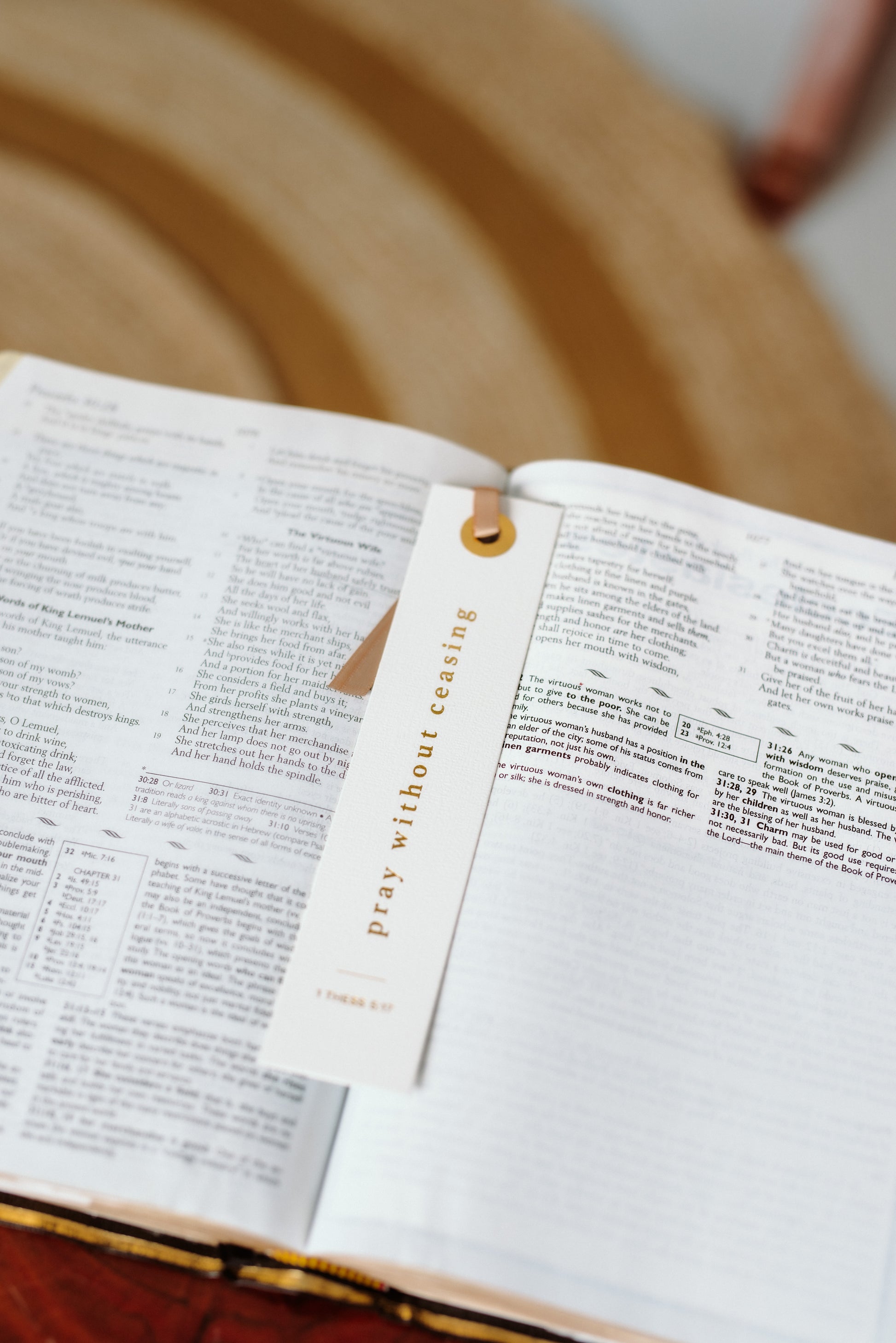 Open Bible  with a Pray without ceasing bookmark inside, on a wooden surface