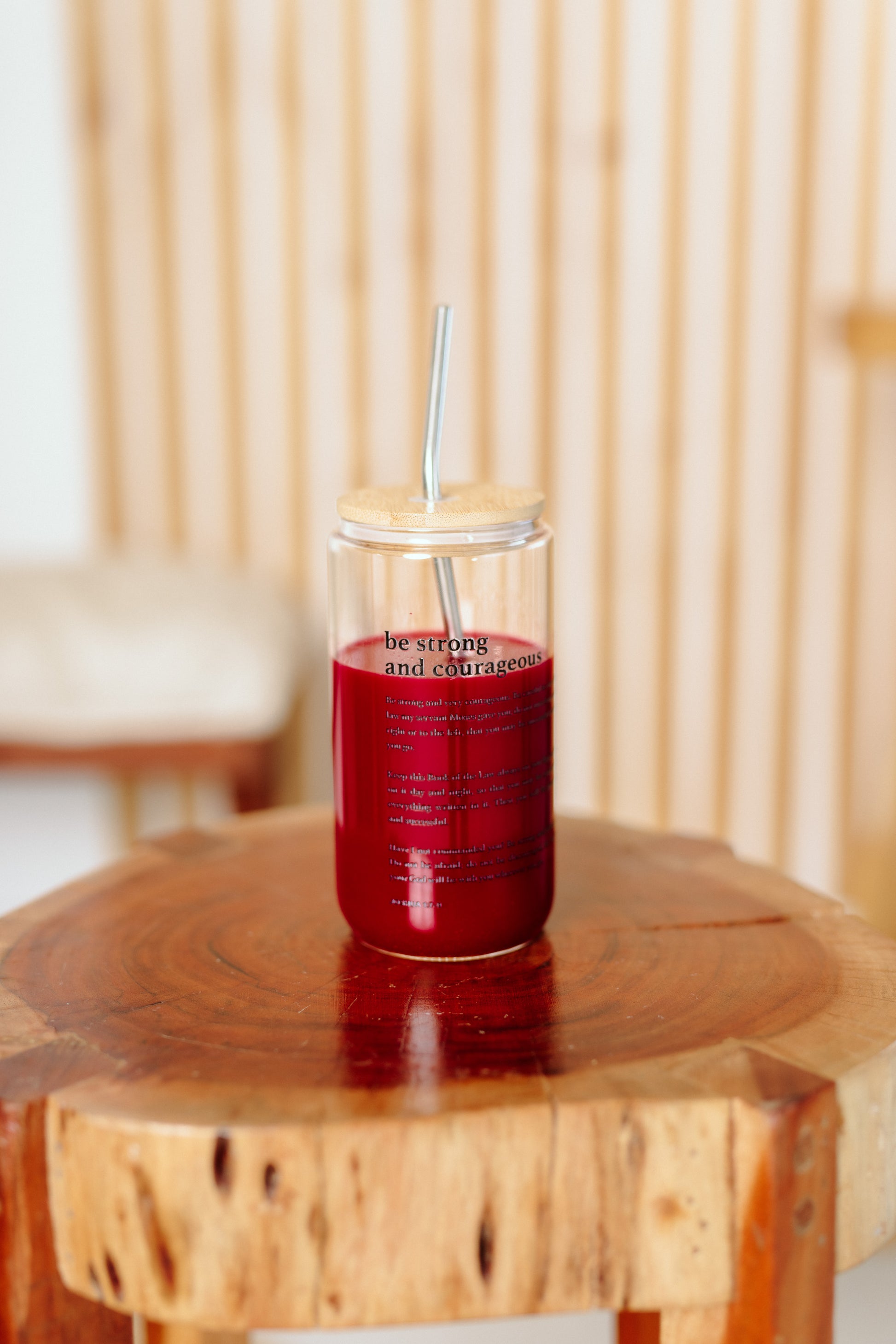 tumbler with a straw on a wooden table